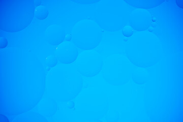 Blue abstract background with oil circles, streaks and gradient.