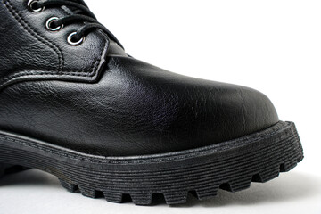 Black leather laced shoe on a white background.