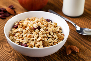 Granola in a plate on a wooden background. Healthy eating