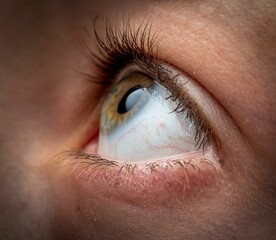 Macro shot of an eyeball of a person looking up