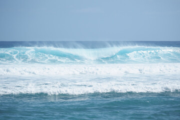 Naklejka na ściany i meble Big powerful turquoise ocean wave crashing. Surf spot.