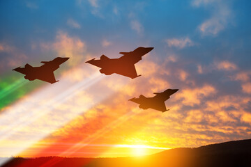 Aircraft silhouettes with flag color trails on background of sunset. Air Force Day. 28 March,...