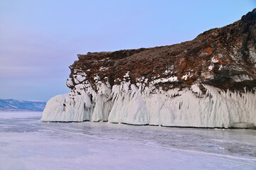 Rock Cliffs with Ice on Frozen Lake Baikal During Vanilla Twilight