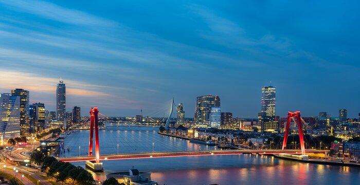 Skyline of Rotterdam at night over the river Maas showing the Willems bridge and the Erasmus bridge