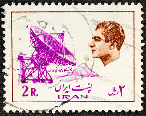 IRAN - CIRCA 1975: A stamp printed in Iran shows Mohammad Reza Pahlavi the last Shah and an earth...