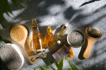 Spa still life with Natural Serums in glass bottle, salt, massager, brush for a body, olive oil...