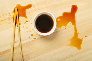 Spilled Soy Sause on Wooden Table, Teriyaki Drops, Oyster Sauce in White Bowl, Balsamic Vinegar...