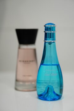 Vertical closeup of Davidoff women's perfume in a blue spray bottle.