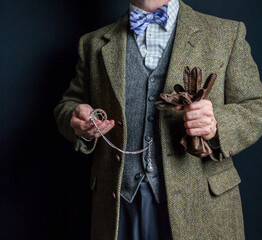 Portrait of British Gentleman in Tweed Suit and Bowler Hat Looking at Pocket Watch. Vintage Style of Classic English Gentleman