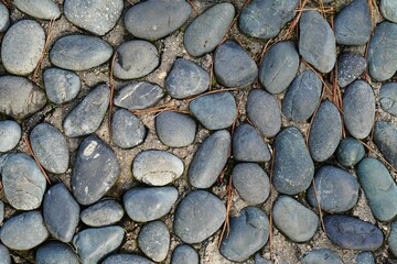 Top view of gray stones next to each other on the ground, perfect as a background
