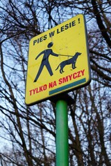 Low angle shot of a sign indicating dogs must be leashed