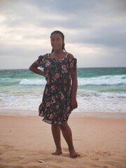 A young african woman poses in the beach