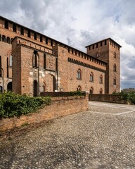 Fototapeta na wymiar Exterior of Visconti Castle of Pavia (Castello Visconteo di Pavia in Italian) under cloudy sky