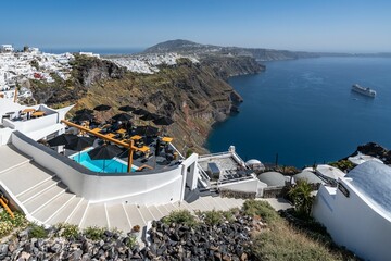 Luxury suites on the cliffs of Santorini overlooking the sea with a view of the island, Greece