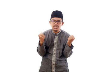 Angry stressed asian muslim man standing while screaming with fist hands. Isolated on white