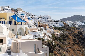 Village of Oia with typical white cave houses on a sunny day
