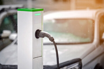 EV charging station and connector. Charger and fast speed station charge. Plug and cable, car at...