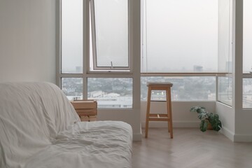 Empty white sofa in minimal apartment room. Concept of emptiness.
