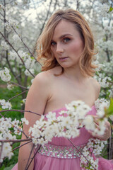 Portrait of a girl in a blooming garden. Blooming trees, traditional asian, travel, seasonal april background.