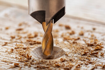 Countersink drill bit with steel triangle ruler make sink in hole for screw in wooden oak plank
