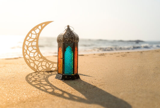 Ramadan Greeting Image lantern lamp and crescent moon on the beach 