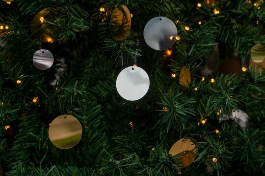 Closeup of Christmas tree decorations with small neons