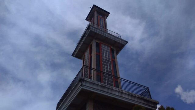 Timelapse footage of the minaret with a background of white clouds moving in the sky