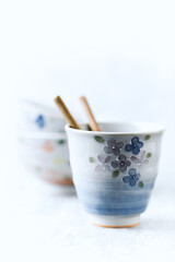 Traditional, handcrafted ceramic on bright wooden background. Soft focus. Copy space.	