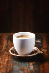 Cup of coffee on wooden background. Close up.	