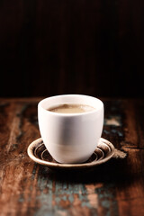 Cup of coffee on wooden background. Close up.	