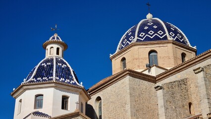 Fototapeta na wymiar Virgin of the Consol church in Altea, Spain against a backdrop of the blue sky
