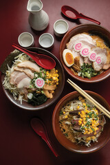 Top view of the Japanese ramen noodle soup on a red table