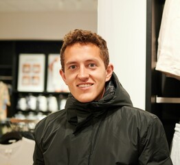 Closeup of a Caucasian man against the blurred background of  a shop