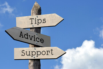 Tips, advice, support - wooden signpost with three arrows, sky with clouds