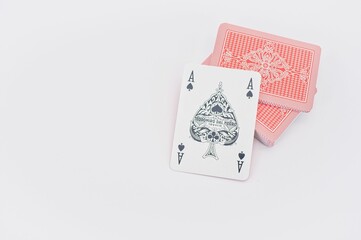 ace of cards and playing cards on a white table surface