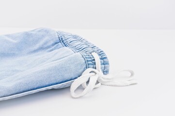 pair of denim jeans on a white table