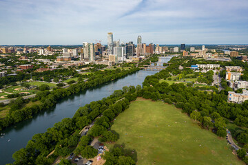 Downtown Austin, Texas skyline cityscape with Colorado River and Lake Austin landscape and Zilker Park - 4K Drone