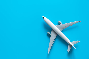 Airplane model on yellow background isolated, flat lay, air ticket, travel and vacation concept, copy space.