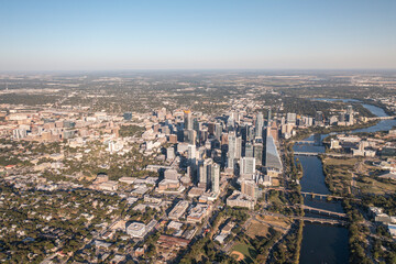 Austin, Texas USA - October 1 2022: Overhead view of downtown Austin, Texas skyline during golden hour sunset with Lady Bird Lake and Colorado River and surrounding landscape 