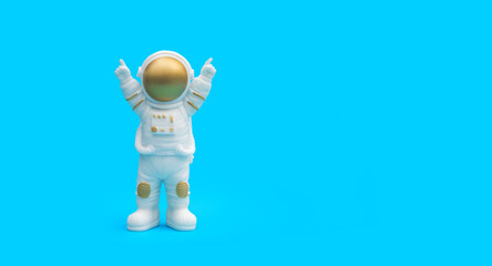 Astronaut on a blue background. Space day. A statuette. Copy space.