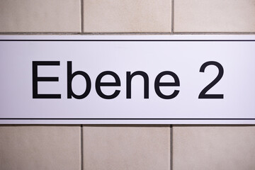 Obraz premium Ebene 2 (Floor two). 2nd floor sign in a stairwell in the parking garage.