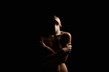 Woman silhouette in the dark. Beautiful Naked Body Girl