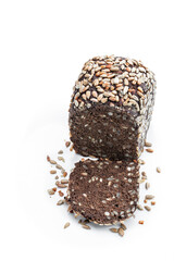 Homemade dark rye bread with sunflower seeds isolated on white