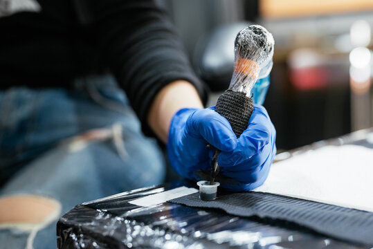 Crop master adding ink to tattoo machine