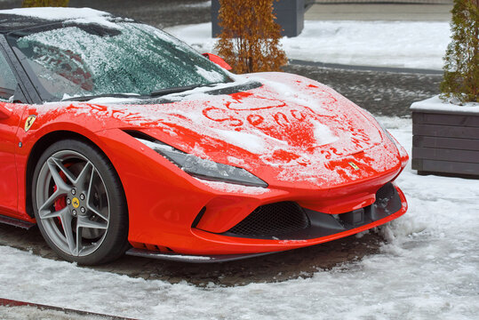 Minsk, Belarus. Jan 2023. Ferrari 488 GTB covered with snow, parked at city street. Red supercar Ferrari 488, Italian sports car produced since 2015. Powered by 3.9 litre twin-turbocharged V8 engine