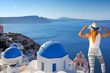 Young woman looking at Oia in Santorini, Greece
