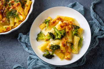 Pasta baked with broccoli and chicken. Broccoli, cheese and gratin sauce on baked penne pasta.