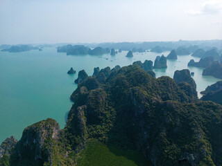 Aerial view floating fishing village and rock island, Ha Long Bay, Vietnam, Southeast Asia. UNESCO...