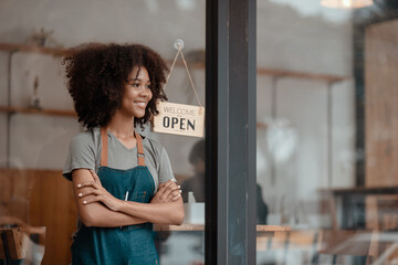 Small business owner standing at  the cafe entrance, Young African American Woman Cafe Owner. 