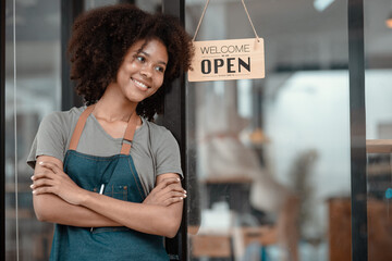 Small business owner standing at  the cafe entrance, Young African American Woman Cafe Owner. 